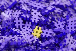 Pile of purple hashtags with one yellow hashtag on top